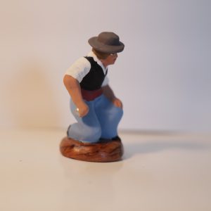 Joueur de pétanque à genoux